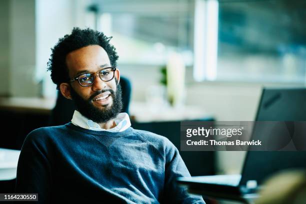 portrait of businessman in office - candid stock pictures, royalty-free photos & images