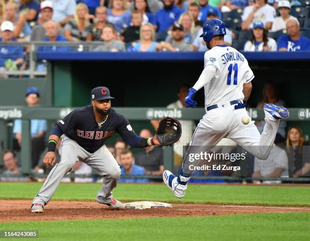 Bubba Starling of the Kansas City Royals beats the throw to first baseman Carlos Santana of the Cleveland Indians for a bunt single in the third...