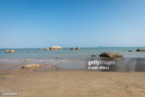 beach and rocks along the coastline in a sunny day in xiamen, fujian, china - 鼓浪嶼 ストックフォトと画像