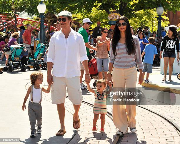 Matthew McConaughey and Camila Alves stroll through Mickey's Toontown with their children, son Levi and daughter Vida at Disneyland park on June 15,...