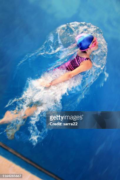 young girl in a swimming pool - swimming stock pictures, royalty-free photos & images