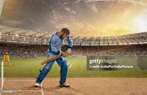 batsman in action in a day & night cricket match - blue dress stock pictures, royalty-free photos & images