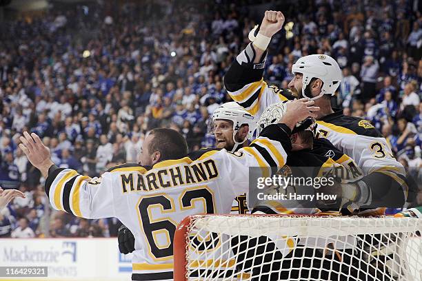 Brad Marchand of the Boston Bruins celebrates with his teammates Tim Thomas and Zdeno Chara after defeating the Vancouver Canucks in Game Seven of...