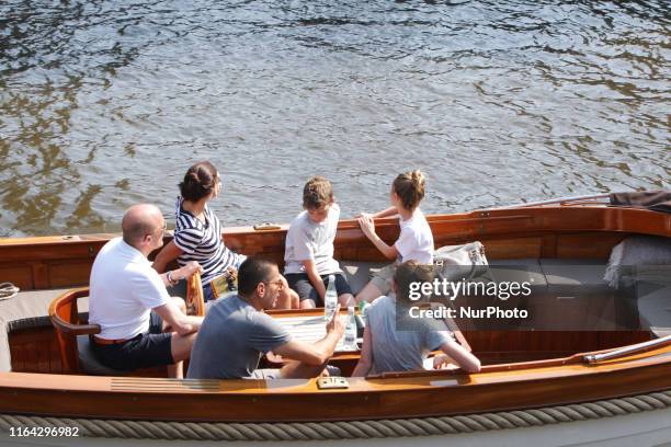 People enjoying on the boat at the Prinsengracht canal during today's afternoon with a temperature of 30 degrees Celsius on August 26, 2019 in...