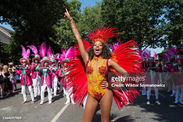 Samba performers in colourful costumes dance to the rhythms of the mobile sound systems along the streets of West London during the grand finale of...