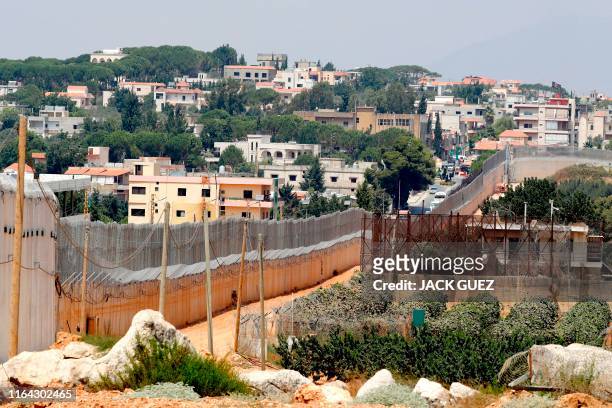 Picture taken on August 27, 2019 shows a partial view of the concrete barrier along the border with Lebanon and the southern Lebanese village of Kfar...