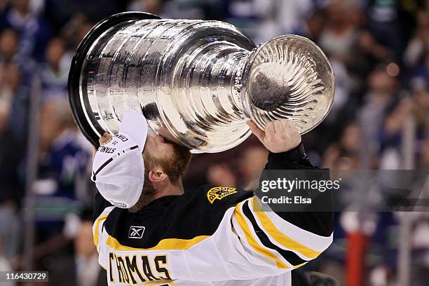 Tim Thomas of the Boston Bruins kisses the Stanley Cup after defeating the Vancouver Canucks in Game Seven of the 2011 NHL Stanley Cup Final at...