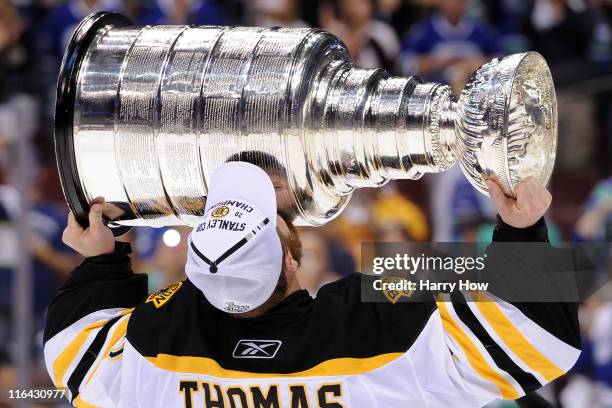 Tim Thomas of the Boston Bruins kisses the Stanley Cup after defeating the Vancouver Canucks in Game Seven of the 2011 NHL Stanley Cup Final at...