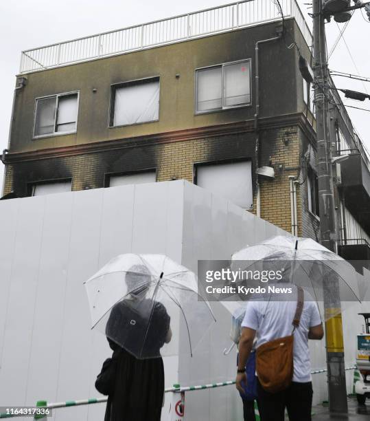 People visit the arson attack-hit studio of Kyoto Animation Co. In Kyoto, western Japan, on Aug. 27, 2019. Police the same day completed the process...
