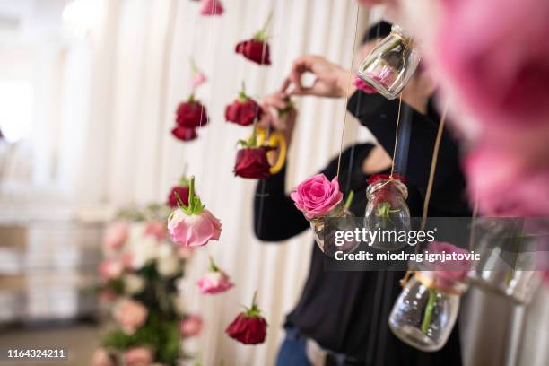 flower designer using scissors while arranging flowers - banquet hall stock pictures, royalty-free photos & images