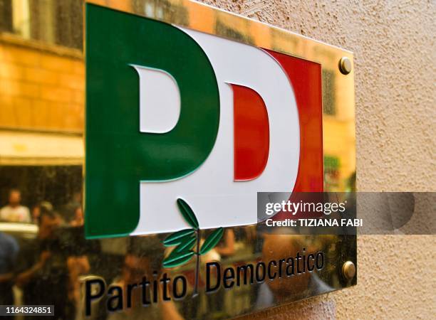 The logo of the Italian Democratic Party is pictured on the facade of its headquarters on August 27, 2019 in downtown Rome. - Italy's president...