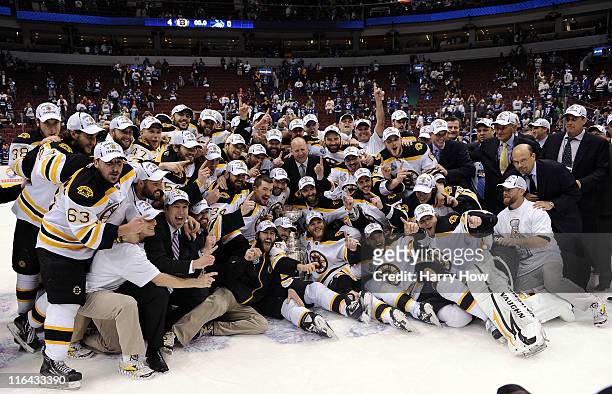 The Boston Bruins pose with the Stanley Cup after defeating the Vancouver Canucks in Game Seven of the 2011 NHL Stanley Cup Final at Rogers Arena on...