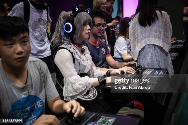 Cosplayer plays a retro video game during the E-Sports and Music Festival Hong Kong 2019 on July 28, 2019 in Hong Kong, China.