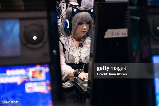 Cosplayer plays a retro video game during the E-Sports and Music Festival Hong Kong 2019 on July 28, 2019 in Hong Kong, China.