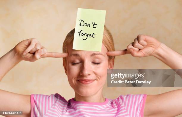 woman committing thoughts to memory - memories stock pictures, royalty-free photos & images