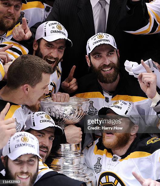 Patrice Bergeron, Andrew Ference, Mark Recchi, and Zdeno Chara of the Boston Bruins pose with the Stanley Cup after defeating the Vancouver Canucks...