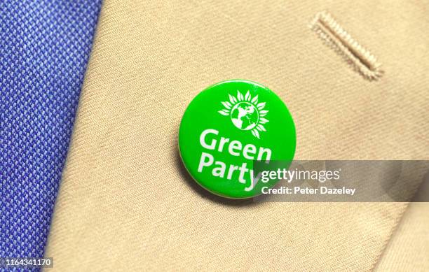 In this photo illustration, a person wears a Green Party badge photographed July 18, 2019 in London.