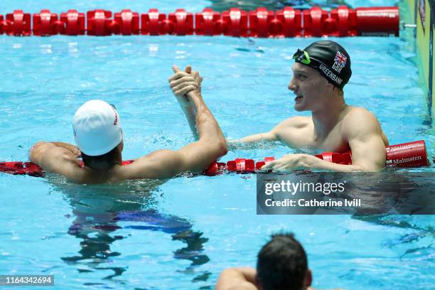 Evgeny Rylov of Russia is congratulated by Luke Greenbank of Great Britain after winning the Men's 200m Backstroke Final on day six of the Gwangju...