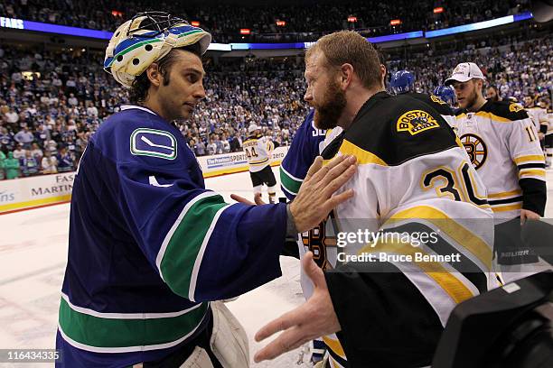 Roberto Luongo of the Vancouver Canucks congratulates Tim Thomas of the Boston Bruins after defeating the Vancouver Canucks in Game Seven of the 2011...