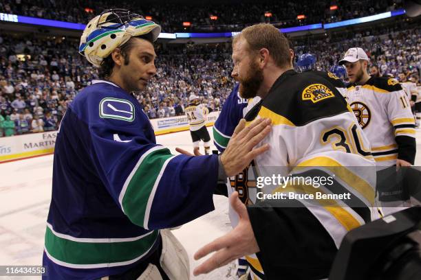 Roberto Luongo of the Vancouver Canucks congratulates Tim Thomas of the Boston Bruins after defeating the Vancouver Canucks in Game Seven of the 2011...