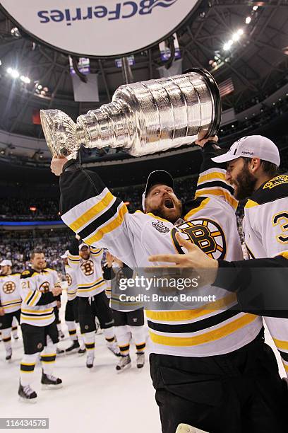 Tim Thomas and Patrice Bergeron of the Boston Bruins celebrate with the Stanley Cup after defeating the Vancouver Canucks in Game Seven of the 2011...