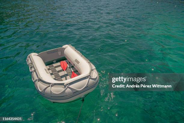 small rubber lifeboat which serves as a rescue boat or shuttle to the shore - lifeboat - fotografias e filmes do acervo