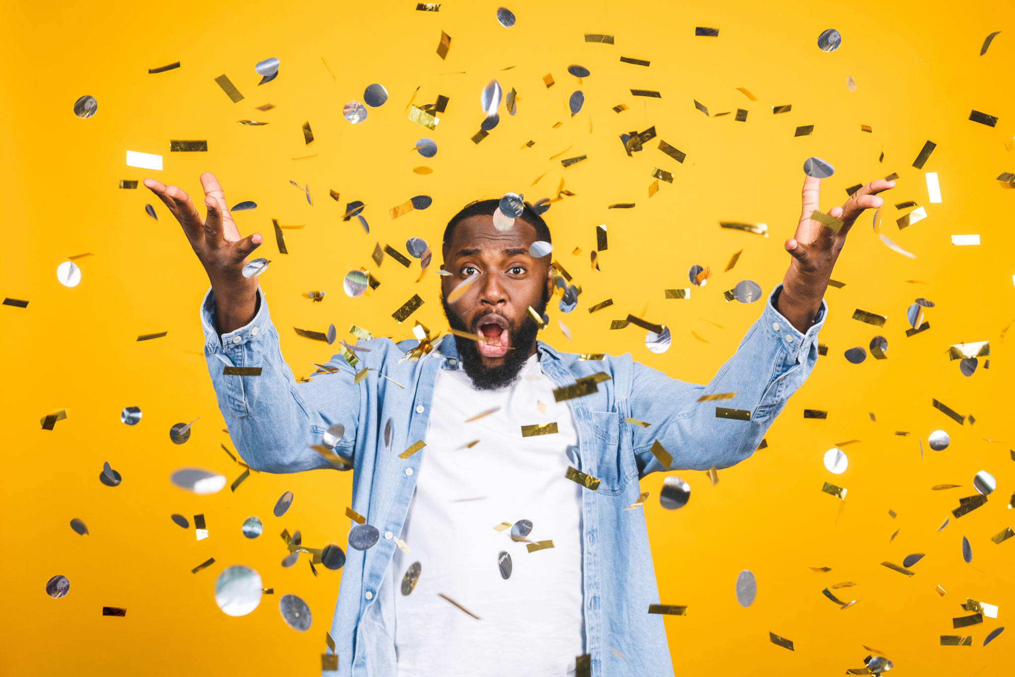 Winner! Cheerful african american young man dancing over yellow background. Winner! Cheerful african american young man dancing over yellow background.