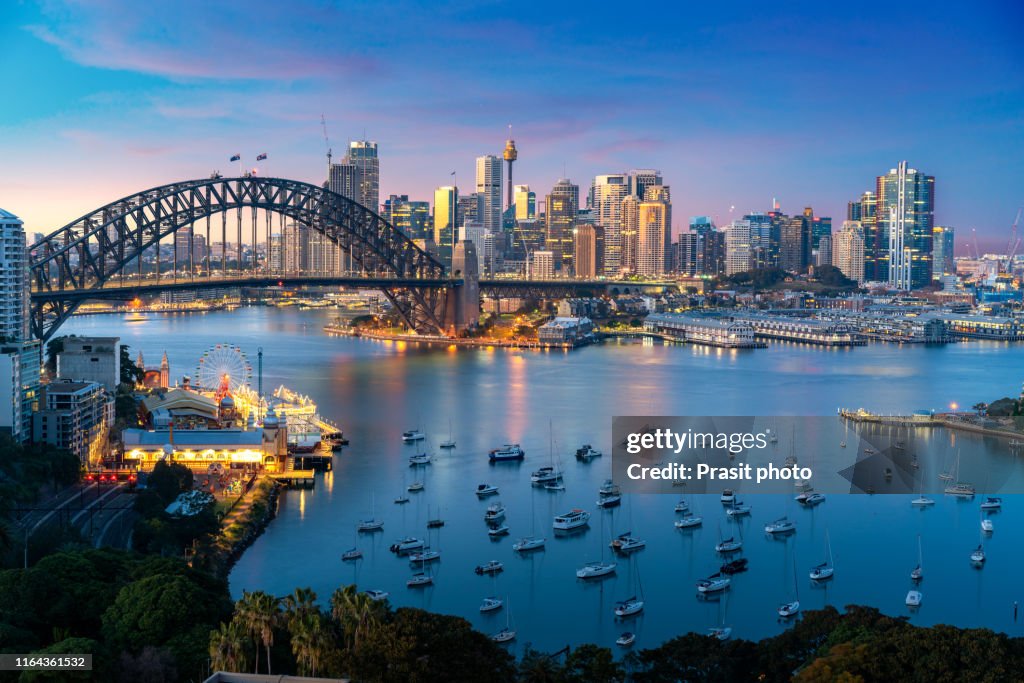 Cityscape image of Sydney, Australia with Harbor Bridge and Sydney skyline during sunset. Vacation and travel in Australia.