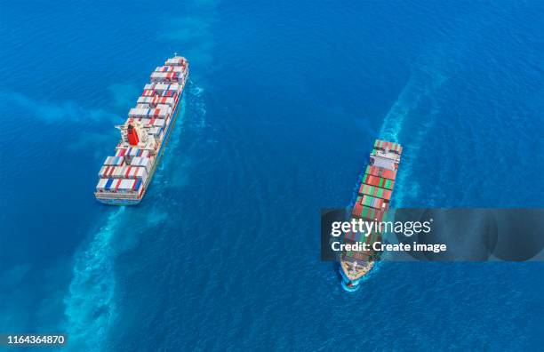 aerial view container ship full load container moving opposite directions on the sea for logistics, import export, shipping or transportation. - two objects stock pictures, royalty-free photos & images