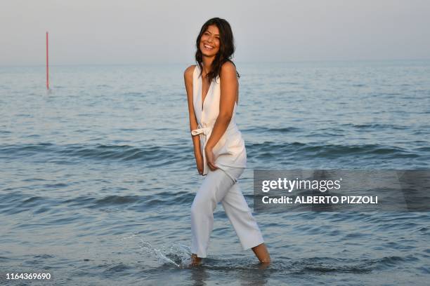 Sponsor of the 76th Venice Film Festival, Italian actress Alessandra Mastronardi poses during a photocall on a Lido beach on August 27, 2019 on the...