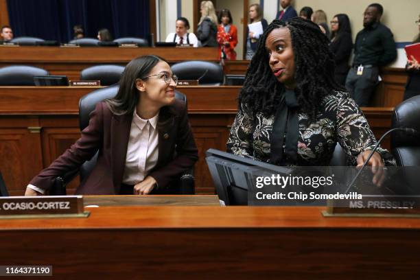 House Oversight and Government Reform Committee members Rep. Alexandria Ocasio-Cortez and Rep. Ayanna Pressley talk before a hearing on drug pricing...