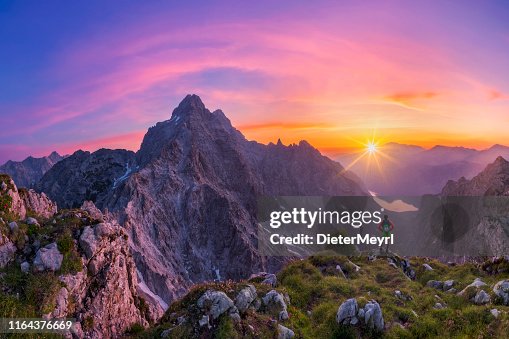 Hiker at glory sunrise with view to Watzmann and Königssee, Nationalpark Berchtesgaden Hiker at glory sunrise with view to Watzmann and Königssee, Nationalpark Berchtesgaden