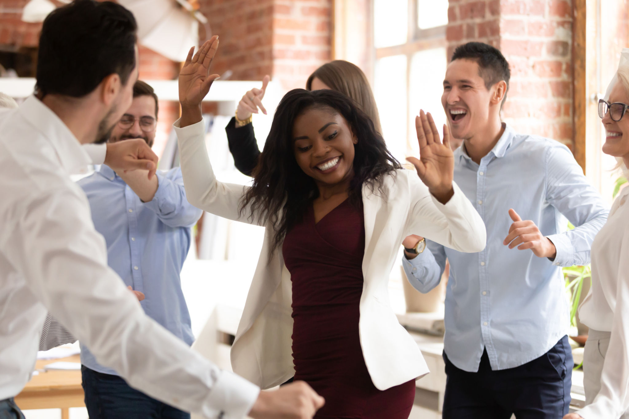 Happy funny black businesswoman with diverse team enjoy victory dance Happy funny black businesswoman with diverse team enjoy victory dance