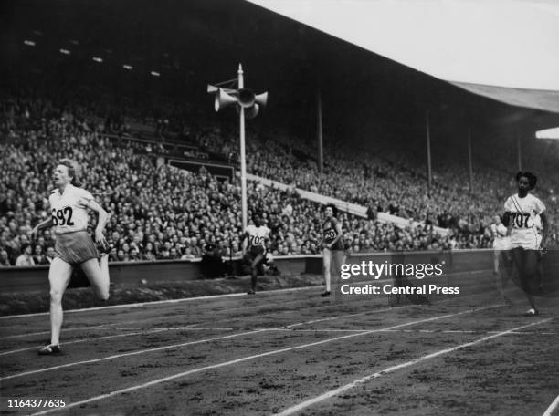 Fanny Blankers-Koen of the Netherlands wins heat 1 of the semi-finals of the Women's 200 Metre event at the Empire Stadium, Wembley, London, during...