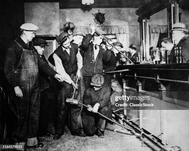 1920s 1930s Prohibition Raid Federal Agents Ripping Up Destroying Bar To See If Liquor Is Hidden