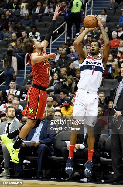 Trevor Ariza of the Washington Wizards shoots the ball against Trae Young of the Atlanta Hawks at Capital One Arena on February 4, 2019 in...