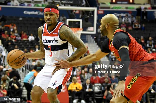 Bradley Beal of the Washington Wizards handles the ball against Vince Carter of the Atlanta Hawks at Capital One Arena on February 4, 2019 in...