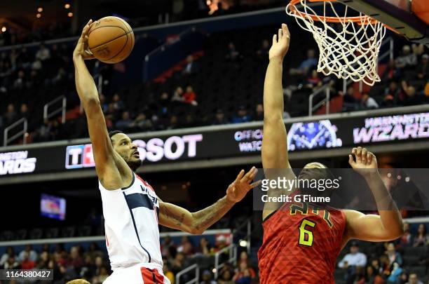 Trevor Ariza of the Washington Wizards drives to the hoop against Omari Spellman of the Atlanta Hawks at Capital One Arena on February 4, 2019 in...