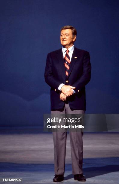 American actor and filmmaker John Wayne talks on stage during his NBC special "Swing Out, Sweet Land" airing on November 29, 1970 in Los Angeles,...