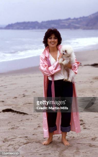 America actress Joyce DeWitt poses for a portrait with her dog at the beach circa 1980 in Los Angeles, California.