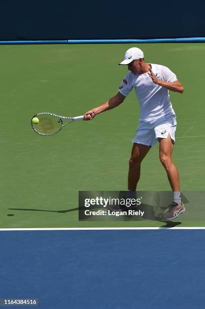 Alex De Minaur of Australia returns a forehand to Bernard Tomic of Australia during the BB&T Atlanta Open at Atlantic Station on July 26, 2019 in...