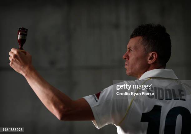 Peter Siddle of Australia poses with a replica Ashes Urn after the Australia Ashes Squad Announcement at The Ageas Bowl on July 26, 2019 in...