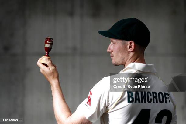 Cameron Bancroft of Australia poses with a replica Ashes Urn after the Australia Ashes Squad Announcement at The Ageas Bowl on July 26, 2019 in...