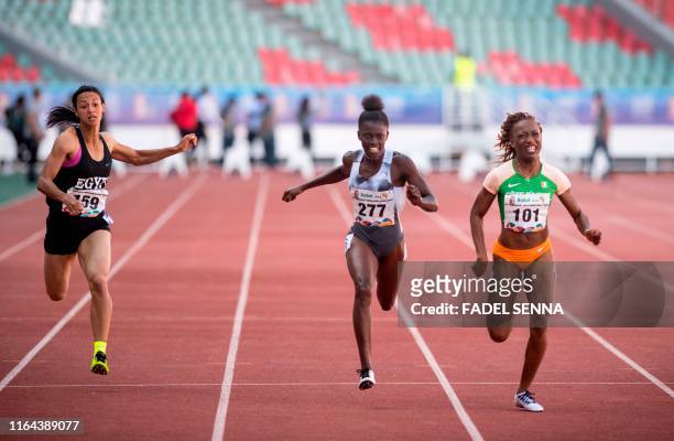 Egypt's Basant Hmeida, Gambia's Gina Bass, and Ivory Cost's Marie-Josee Ta Lou compete during the 100m Women's Final at the 12th edition of the...