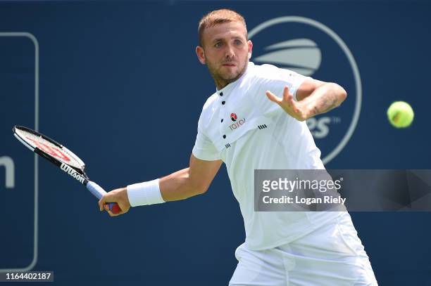 Daniel Evans of Great Britain returns a forehand to Reilly Opelka of the United States during the BB&T Atlanta Open at Atlantic Station on July 26,...