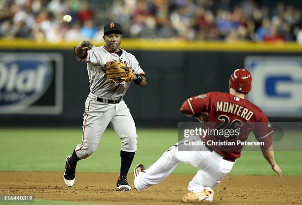 Infielder Miguel Tejada of the San Francisco Giants throws over the sliding Miguel Montero of the Arizona Diamondbacks to complete a double play...