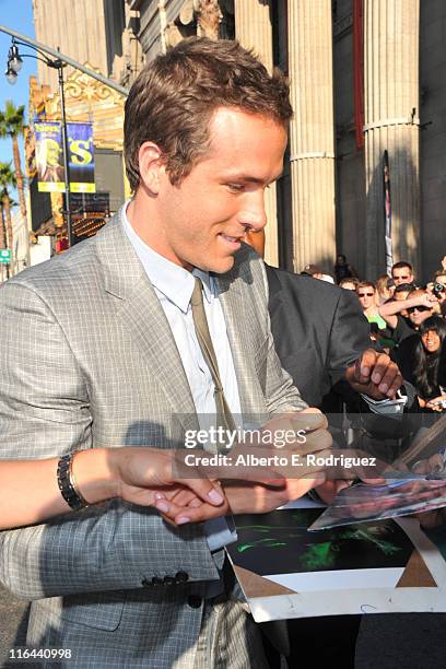 Actor Ryan Reynolds signs autographs at the premiere of Warner Bros. Pictures' "Green Lantern" held at Grauman's Chinese Theatre on June 15, 2011 in...