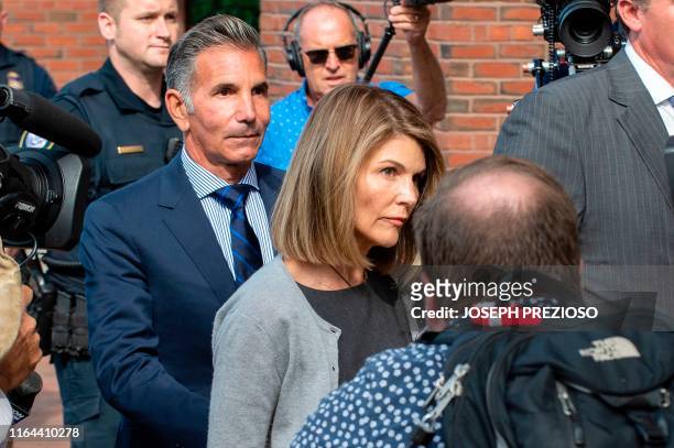 Actress Lori Loughlin and husband Mossimo Giannulli exit the Boston Federal Court house after a pre-trial hearing with Magistrate Judge Kelley at the...