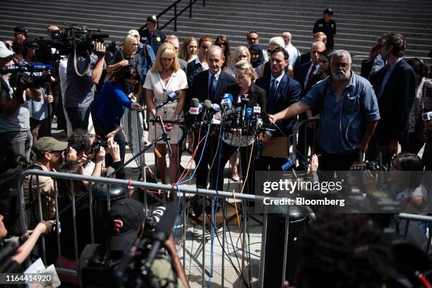 Chauntae Davies, an alleged victim of Jeffrey Epstein, center, speaks to members of the media outside of federal court in New York, U.S., on Tuesday,...