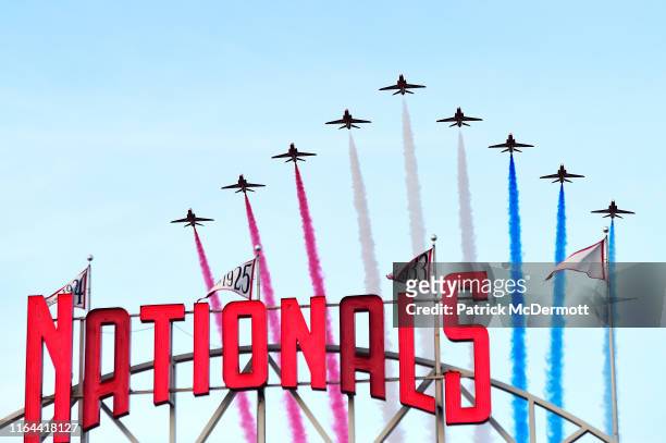 The Royal Air Force Red Arrows fly over National Park before the interleague game between the Baltimore Orioles and Washington Nationals at Nationals...
